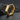 Angled view of handcrafted hexagon hoop earring resting on dark textured stone showing the concealed hinged closure