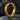 Close-up macro shot of the ancient Greek key motif on the sterling silver hoop resting on a textured dark stone