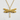 Close-up of gold dragonfly pendant showcasing intricate wing veins resting on a white textured surface