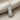 Swim Mantra Pendant, polished silver, angled view on fabric