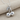 Twin Cherry Pendant, polished, angled view on fabric