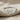 Petite Bow Ring, polished, front view on textured fabric