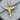 Close-up view of the stylized submachine gun pendant resting on a textured wooden surface highlighting grip details