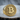 Macro shot of the handcrafted Bitcoin labyrinth ring resting on textured wood showcasing the metalwork.