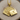 Close-up view of gold vermeil playing cards pendant featuring the ten through ace of hearts straight flush