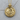 Detailed view of the oxidized silver and gold vermeil sun moon pendant resting flat on a textured wooden surface