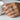 Spread Wings Ring, worn on model hand holding a coffee cup