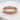 Woven Braid Ring, rose gold, front view on stone surface