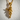 Close-up of the handcrafted praying angel pendant in gold vermeil resting against a textured white background
