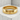 Close-up of polished gold vermeil Japanese love ring showing deep oxidized calligraphy on a textured concrete block
