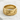 Close-up of premium Great Wave ring resting on textured white stone highlighting intricate sculptural wave details.