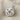 Close-up of the handcrafted Gordian knot pendant resting on textured fabric highlighting its polished strands