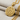 Peace Love Pendant, gold vermeil, angled view on fabric