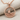 Sailboat Wave Pendant, rose plated silver, front view on fabric