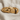 Embracing Hands Ring, gold vermeil, angled front view on fabric