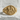 Side angle view of the Good Shepherd signet ring with side cross details displayed on white plaster rock