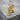 Acacia Sprig Lapel Pin, gold vermeil, angled view on stone