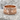 Si Vis Pacem Swords Ring in rose gold, front view on stone surface