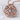 Witches Knot Pendant, rose gold, product photo on textured surface