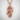 Lung Dragon Pearl Pendant, rose plated silver, front view on textured background
