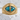 Turquoise dragon eye ring, gold vermeil, front view on stone pedestal