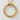 Close up view of detailed ouroboros serpent circular pendant displayed against a textured off white wall surface