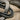 Macro extreme close-up of oxidized silver Solomon knot pendant displaying intricate hand-finished details