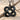 Solomon Knot Pendant, black rhodium, product photo on sand