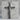 Halo Corpus Crucifix Pendant, oxidized, on grey stone pedestal