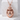 Hatching Dragon Egg Pendant, rose gold plated, product photo on stone block