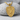 Saint Michael Crest Pendant, gold vermeil, front view on textured stone