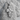 Christ Profile Cross Pendant, polished silver, front view resting on stone