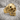 Stitched Skull Ring, gold vermeil, product photo on porous stone