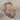 Eternity interlinked heart ring in rose plated silver, angled front view on fabric