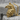 Eagle Bust Pendant, gold vermeil, angled product photo resting on stone
