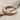 Bull horn cuff earring, rose gold vermeil, angled view on fabric