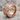 No Days Off Ring in rose gold, angled view on rock