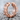 Gear hoop earring in rose gold, angled product photo on stone