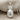 Hospitality Pineapple Pendant, polished silver, front view on linen
