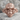 Biomechanical Spine Skull Ring, rose gold, front view on stone surface