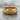 Acanthus flower band ring, gold vermeil, front view on wet stone surface