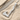 Braided Viking Axe Pendant, polished, angled view on sand