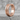 Segmented Industrial Hoop Earring, rose gold, front view on stone
