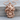 Coiled Snake Skull Pendant, rose gold, product photo on wood