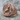 Mermaid Skull Signet Ring, rose gold, angled view on rock