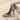 Stiletto High Heel Pendant, black rhodium, angled view on sand