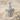 Ribbon cross pendant, polished, product photo on sand