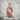 Perched Raven Pendant, rose gold, angled product photo on stone