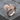 Raven Feather Fan Ring in rose gold, product photo on rustic wood
