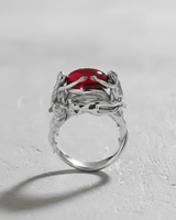925 sterling silver nymph ring featuring three female figures holding a red cabochon stone